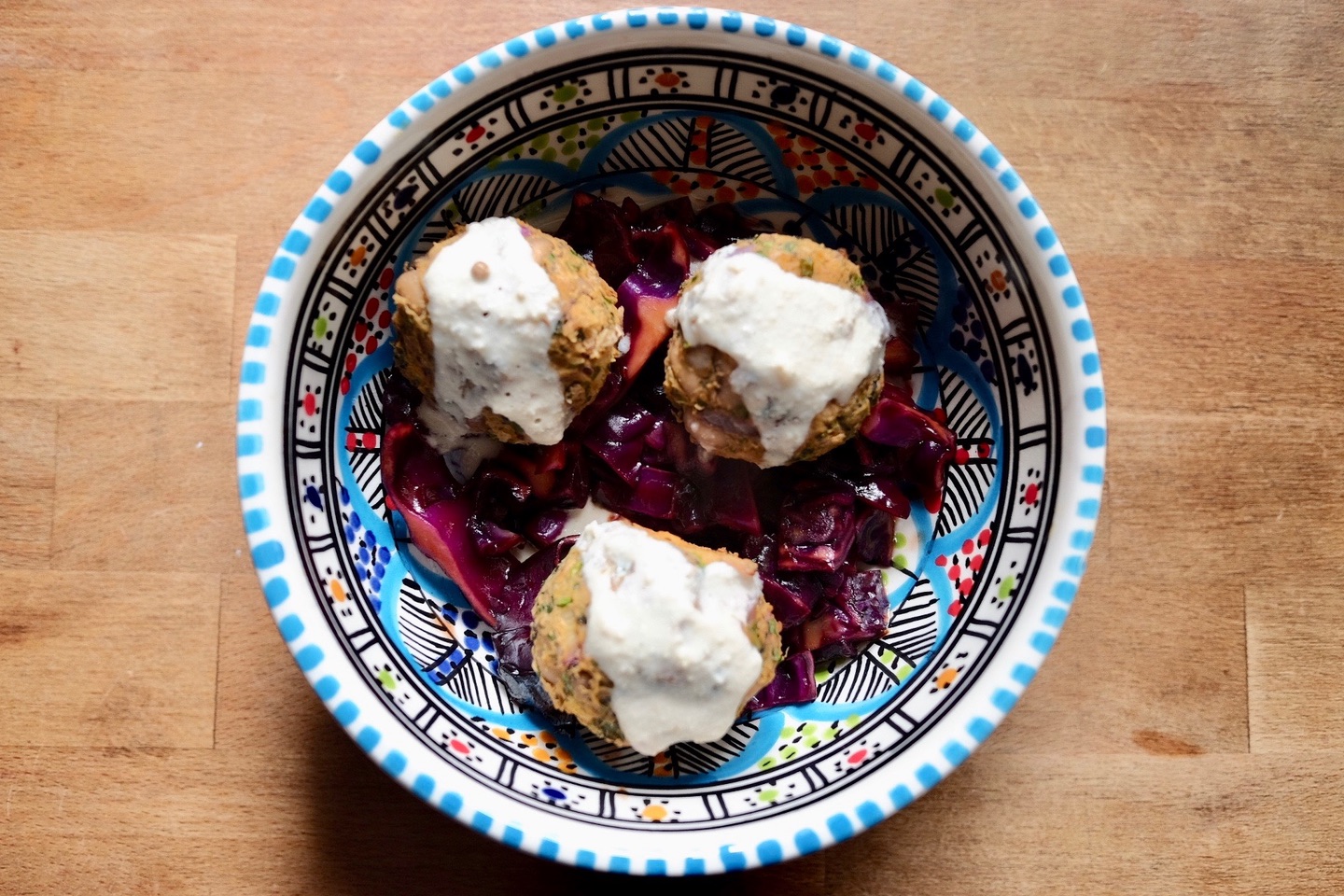 baked blackeye bean balls with red cabbage and a tahini dressing