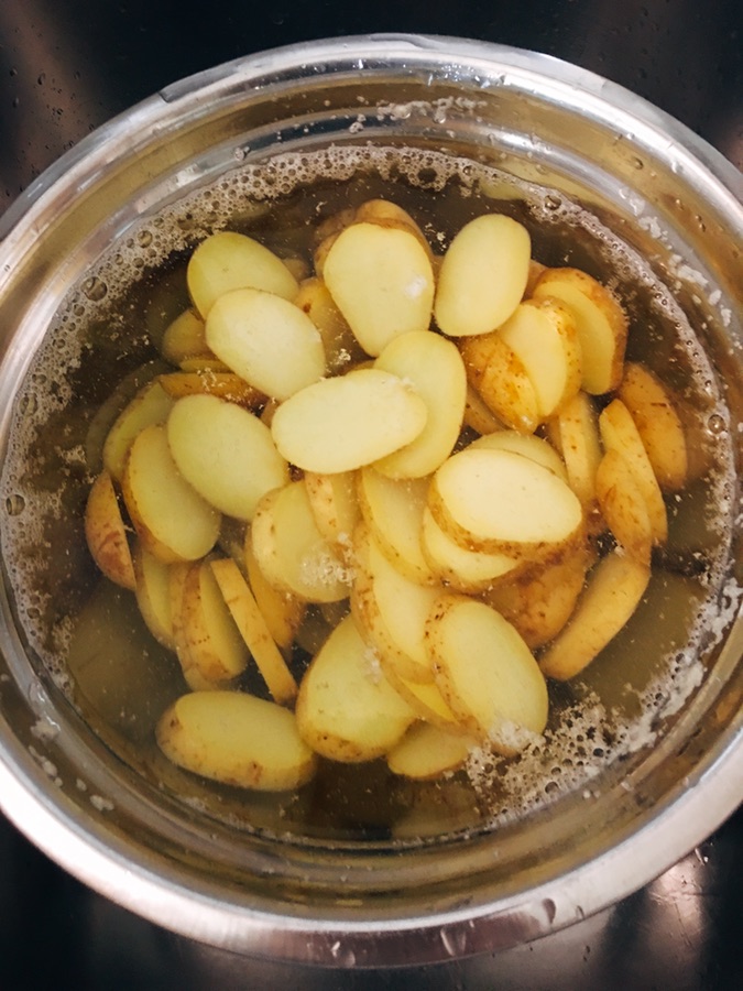 Cooked potatoes in cold water